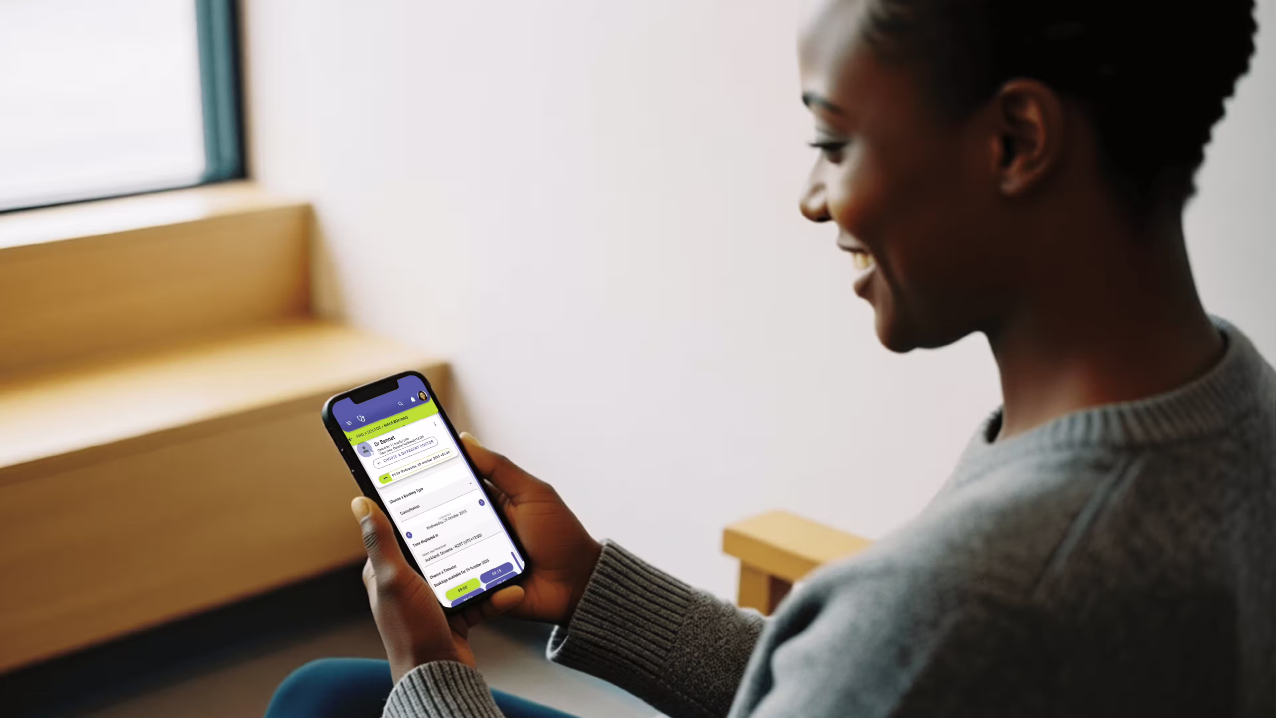 Patient using mobile scheduling software to book clinic appointment in Namibia