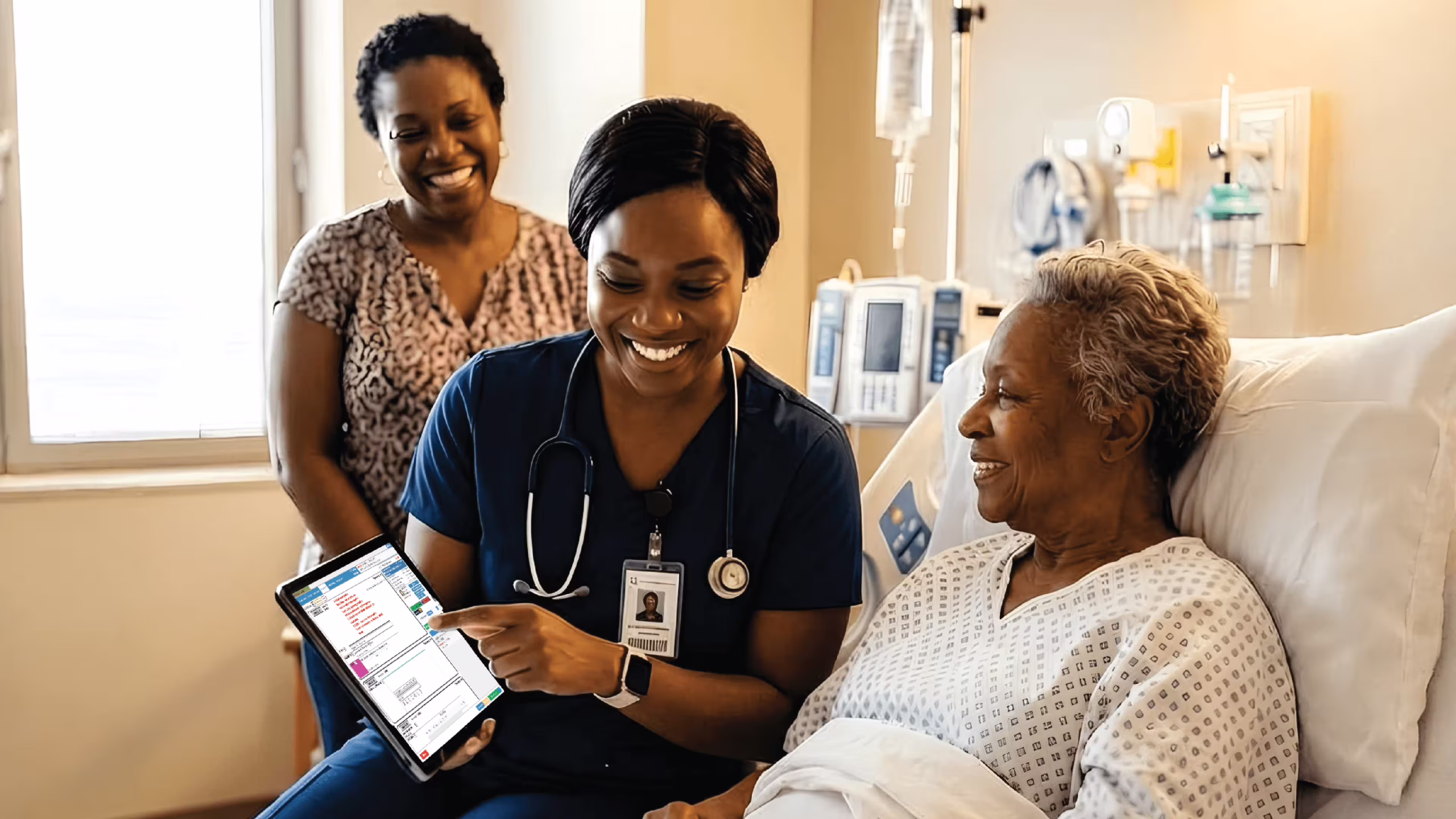 Close-up of a Namibian nurse or doctor confidently using EMR software on a tablet at a patient’s bedside, with warm lighting and a smiling patient in the background